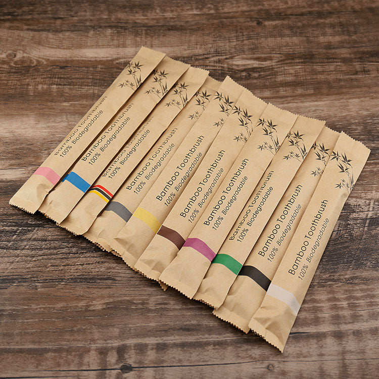 Set of wooden toothbrush packaging on a wooden surface